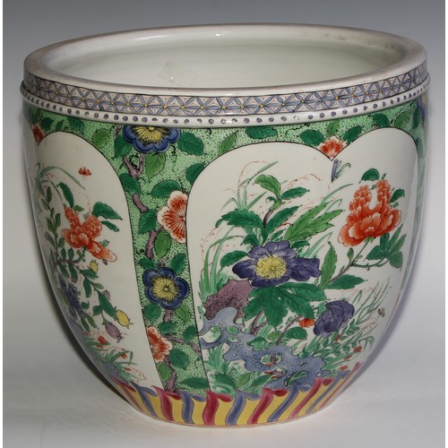 397 - A Chinese ovoid jardiniere, decorated in the famille verte palette with flowers, rock work and insec... 