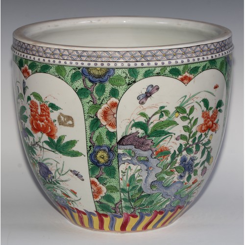 397 - A Chinese ovoid jardiniere, decorated in the famille verte palette with flowers, rock work and insec... 