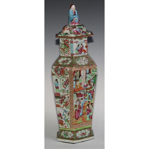 455 - A pair of Chinese famille rose hexagonal vases and covers, painted in the typical Cantonese manner w... 