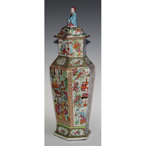 455 - A pair of Chinese famille rose hexagonal vases and covers, painted in the typical Cantonese manner w... 