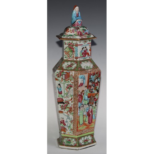 455 - A pair of Chinese famille rose hexagonal vases and covers, painted in the typical Cantonese manner w... 