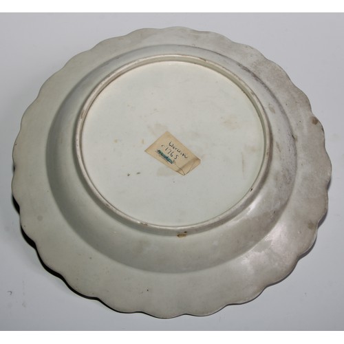 186 - A pair of Worcester shaped circular plates, painted in polychrome with scattered flowers, brown line... 