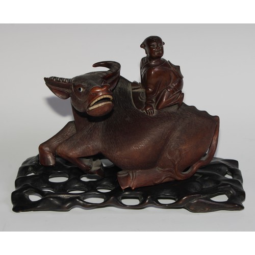 425 - A pair of Chinese hardwood carvings, of boys riding buffalo, glass eyes, bone teeth, carved bases, 3... 