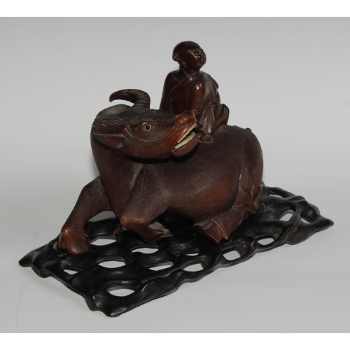 425 - A pair of Chinese hardwood carvings, of boys riding buffalo, glass eyes, bone teeth, carved bases, 3... 