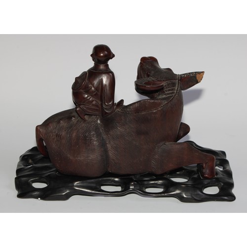 425 - A pair of Chinese hardwood carvings, of boys riding buffalo, glass eyes, bone teeth, carved bases, 3... 