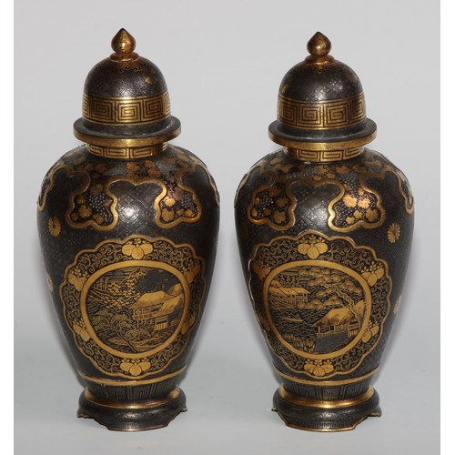 429 - A pair of Japanese iron and shakudo ovoid vases and covers, decorated with birds, landscapes and fru... 