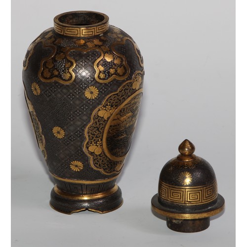 429 - A pair of Japanese iron and shakudo ovoid vases and covers, decorated with birds, landscapes and fru... 