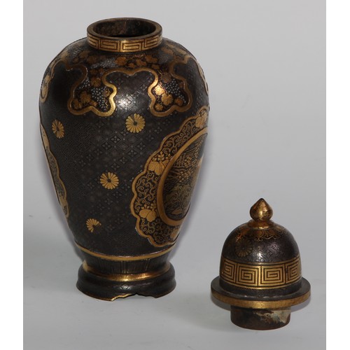 429 - A pair of Japanese iron and shakudo ovoid vases and covers, decorated with birds, landscapes and fru... 