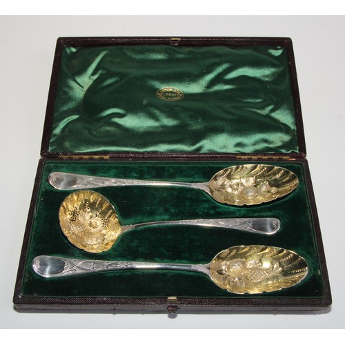 792 - A pair of George III silver Hanoverian pattern berry spoons, with sifter en suite, gilt bowls, the s... 