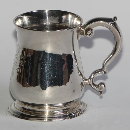 895 - A George II silver bell shaped half-pint mug, scroll-capped handle, skirted base, crested, 10cm high... 