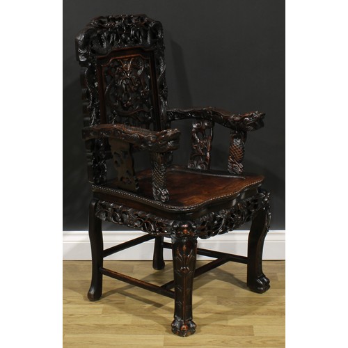 1650 - A Chinese hardwood armchair, carved throughout with dragons, serpentine seat with beaded border, cab... 