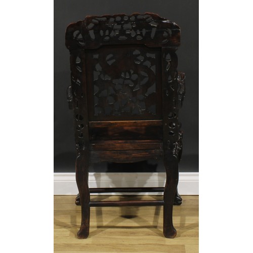 1650 - A Chinese hardwood armchair, carved throughout with dragons, serpentine seat with beaded border, cab... 