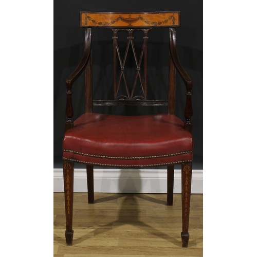 1981 - A pair of Sheraton Revival mahogany and marquetry elbow chairs, each cresting rail inlaid with an ur... 