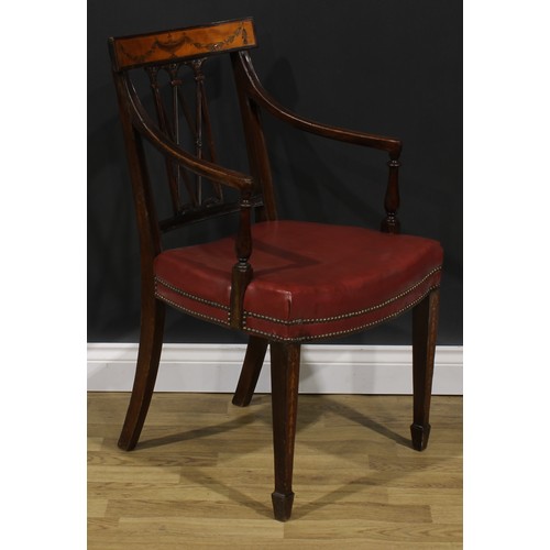 1981 - A pair of Sheraton Revival mahogany and marquetry elbow chairs, each cresting rail inlaid with an ur... 