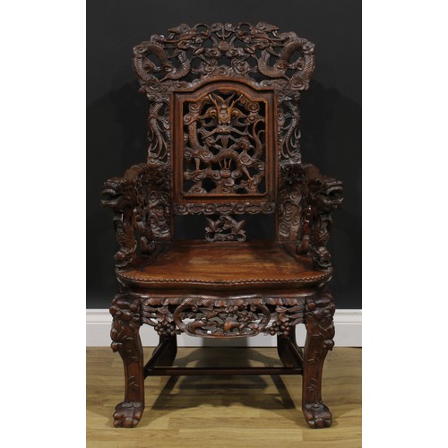 1863 - A pair of Chinese hongmu armchairs, carved throughout with dragons and stylised clouds, serpentine s... 