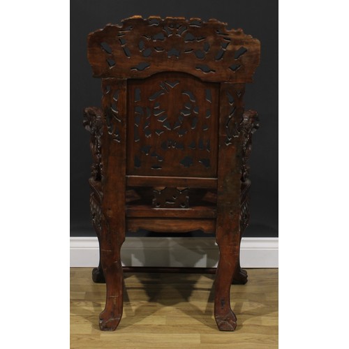 1863 - A pair of Chinese hongmu armchairs, carved throughout with dragons and stylised clouds, serpentine s... 