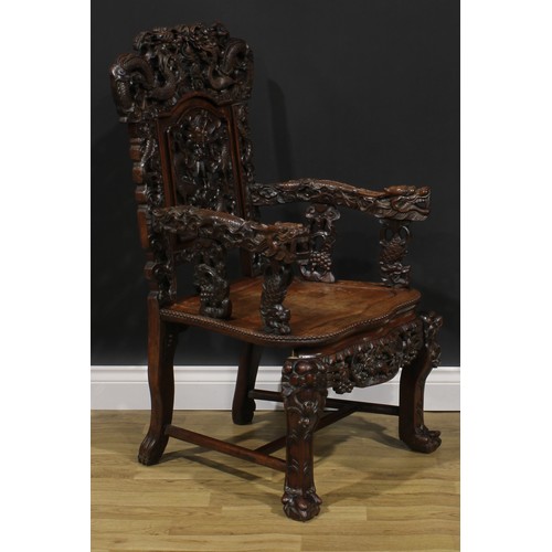 1863 - A pair of Chinese hongmu armchairs, carved throughout with dragons and stylised clouds, serpentine s... 