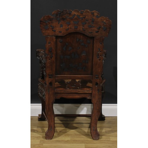 1863 - A pair of Chinese hongmu armchairs, carved throughout with dragons and stylised clouds, serpentine s... 