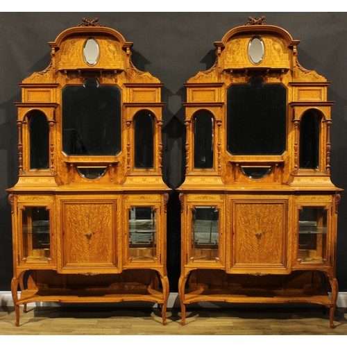 2528 - A pair of Sheraton Revival satinwood drawing room cabinets, each with arched cresting surmounted by ... 