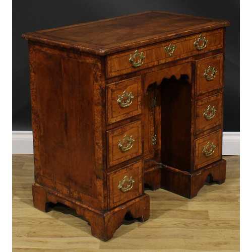 2111 - A George II walnut kneehole desk, burrbanded quarter-veneered rectangular top with moulded edge abov... 