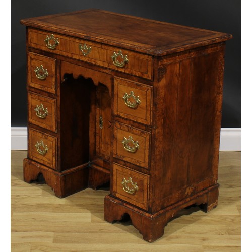 2111 - A George II walnut kneehole desk, burrbanded quarter-veneered rectangular top with moulded edge abov... 