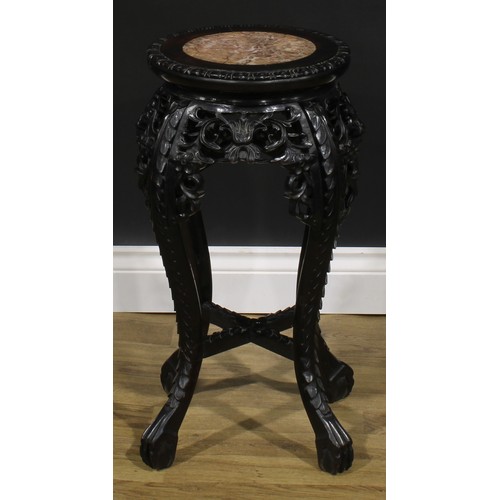 2100 - A Chinese hardwood jardiniere stand, circular top with inset marble panel, shaped apron pierced and ... 