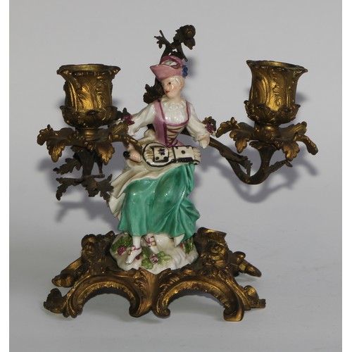 2087 - A pair of German porcelain figures, of musicians, mounted upon a pair of ormolu two-light candelabra... 