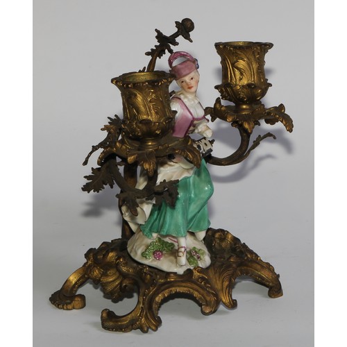 2087 - A pair of German porcelain figures, of musicians, mounted upon a pair of ormolu two-light candelabra... 