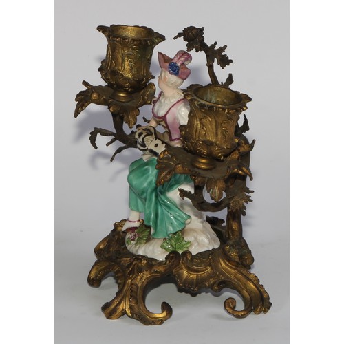 2087 - A pair of German porcelain figures, of musicians, mounted upon a pair of ormolu two-light candelabra... 