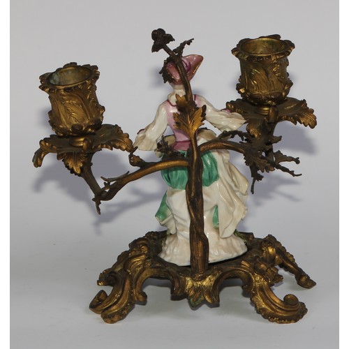 2087 - A pair of German porcelain figures, of musicians, mounted upon a pair of ormolu two-light candelabra... 