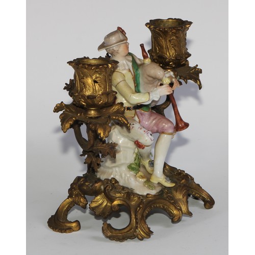 2087 - A pair of German porcelain figures, of musicians, mounted upon a pair of ormolu two-light candelabra... 