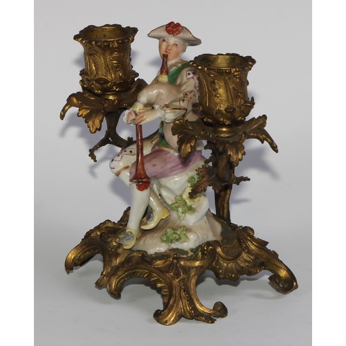 2087 - A pair of German porcelain figures, of musicians, mounted upon a pair of ormolu two-light candelabra... 