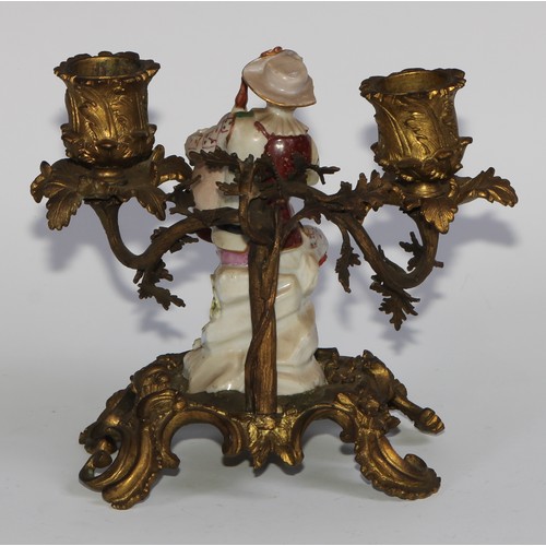 2087 - A pair of German porcelain figures, of musicians, mounted upon a pair of ormolu two-light candelabra... 