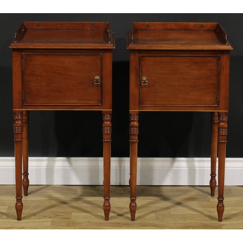 1978 - A pair of Regency Revival beech bedroom night cupboards, each with a three-quarter gallery pierced w... 