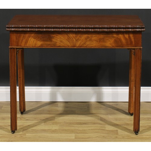 2175 - A George III mahogany tea table, hinged top with carved edge above a flame-veneered frieze, moulded ... 