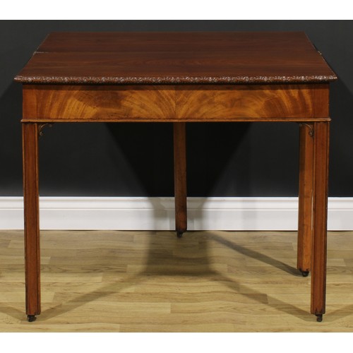 2175 - A George III mahogany tea table, hinged top with carved edge above a flame-veneered frieze, moulded ... 