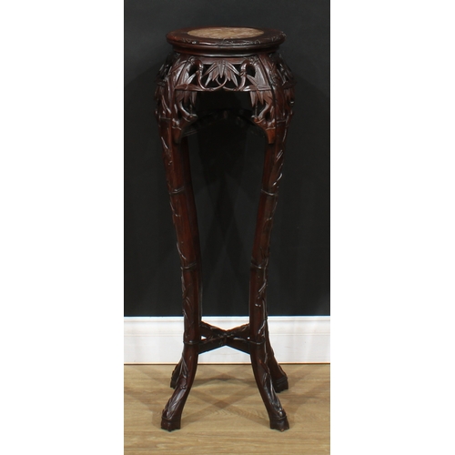 2101 - A Chinese hardwood jardiniere stand, circular top with inset soapstone panel, above a shaped frieze ... 