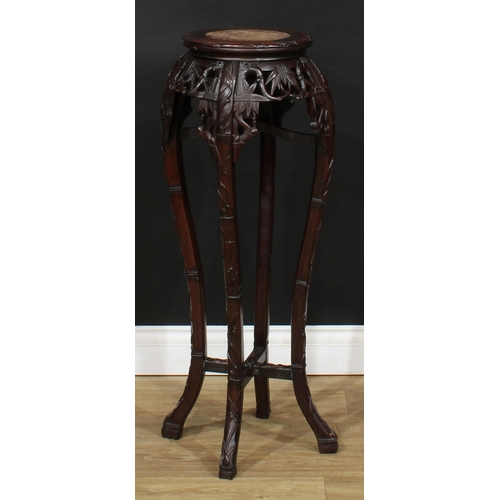 2101 - A Chinese hardwood jardiniere stand, circular top with inset soapstone panel, above a shaped frieze ... 