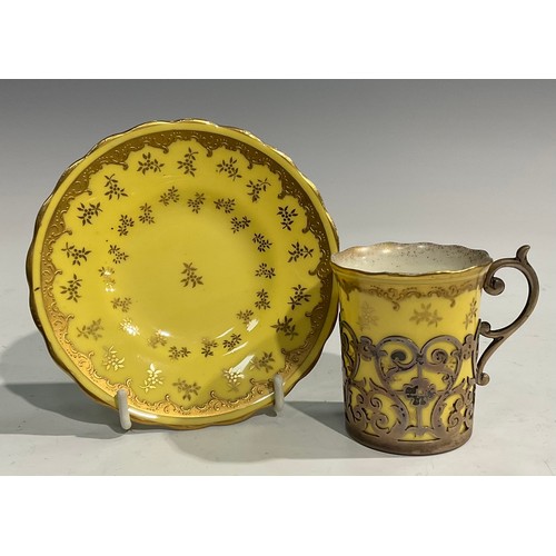 170 - A set of six Coalport coffee cans and saucers, gilt floral flowers on a primrose yellow ground, each... 