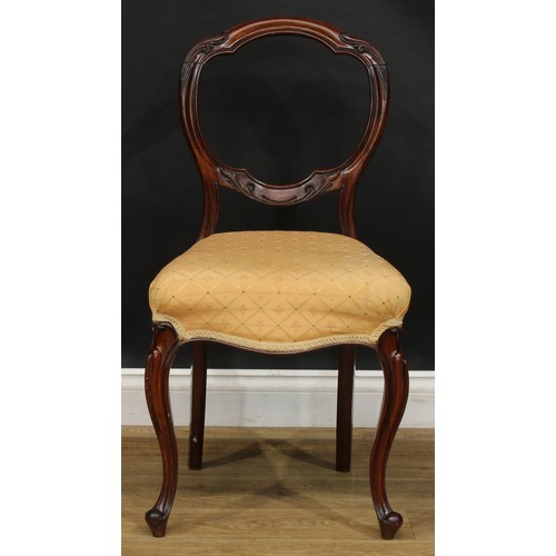 2182 - A set of four Victorian rosewood balloon back dining chairs, each with a shaped back carved and appl... 