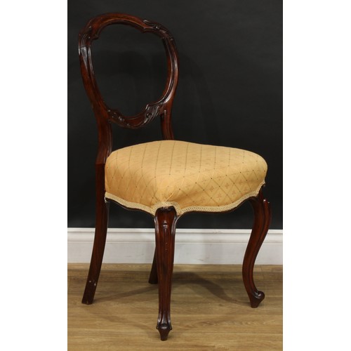 2182 - A set of four Victorian rosewood balloon back dining chairs, each with a shaped back carved and appl... 