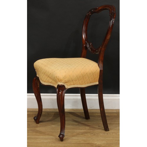 2182 - A set of four Victorian rosewood balloon back dining chairs, each with a shaped back carved and appl... 