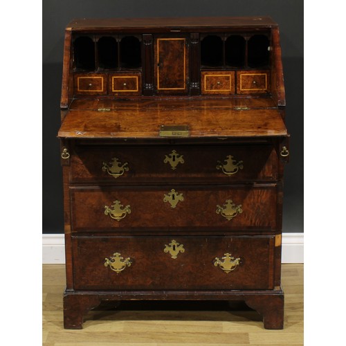 2185 - An 18th century and later walnut and mahogany bureau, fall front enclosing a small door, small drawe... 