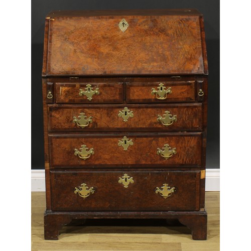 2185 - An 18th century and later walnut and mahogany bureau, fall front enclosing a small door, small drawe... 