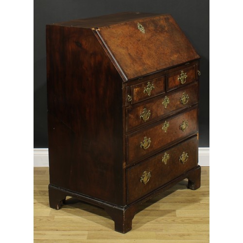 2185 - An 18th century and later walnut and mahogany bureau, fall front enclosing a small door, small drawe... 