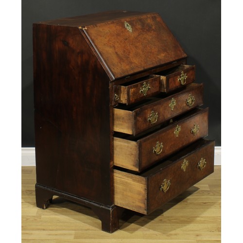 2185 - An 18th century and later walnut and mahogany bureau, fall front enclosing a small door, small drawe... 