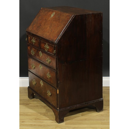 2185 - An 18th century and later walnut and mahogany bureau, fall front enclosing a small door, small drawe... 