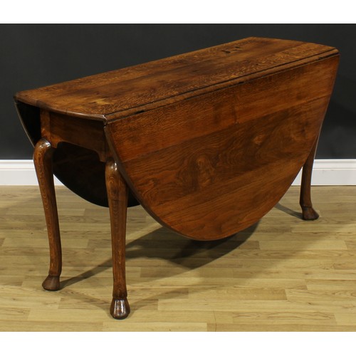 2103 - A George II Revival oak gateleg dining table, oval top with fall leaves, cabriole legs, hoof feet, 7... 