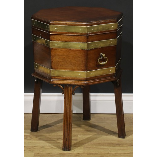 2124 - A George III Revival brass-bound mahogany octagonal cellarette or wine cooler, hinged top, removable... 