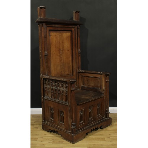 2569 - A substantial Gothic Revival oak throne-form chair, rectangular back, plank seat, carved and applied... 